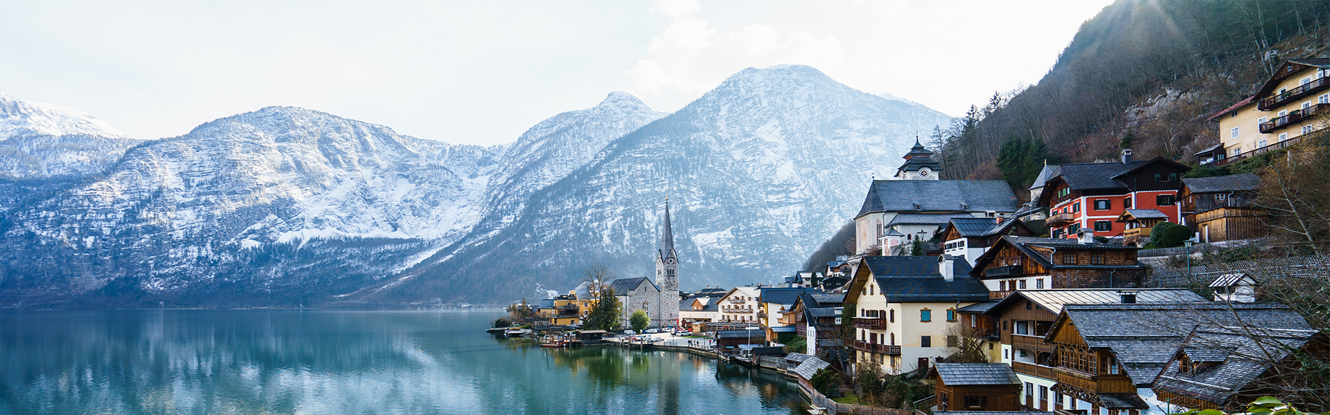 beautiful shot small village surrounded by lake snowy hills